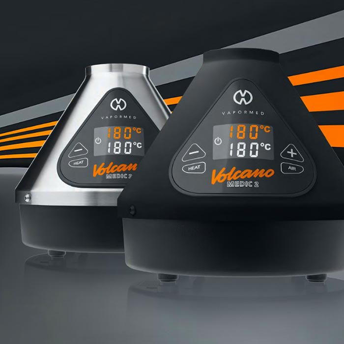 Two Volcano MEDIC 2 vaporizers with digital displays on a dark background.