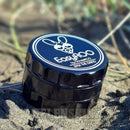 EasyRoo 3pc 63mm Non-Stick Grinderoo Grinder sitting on black sand at beach NZ