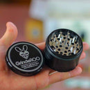 Black OG 'GrindeRoo' 63mm grinder held in a hand