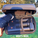 Mighty Medic soft case with compartments held by a gloved hand outdoors.